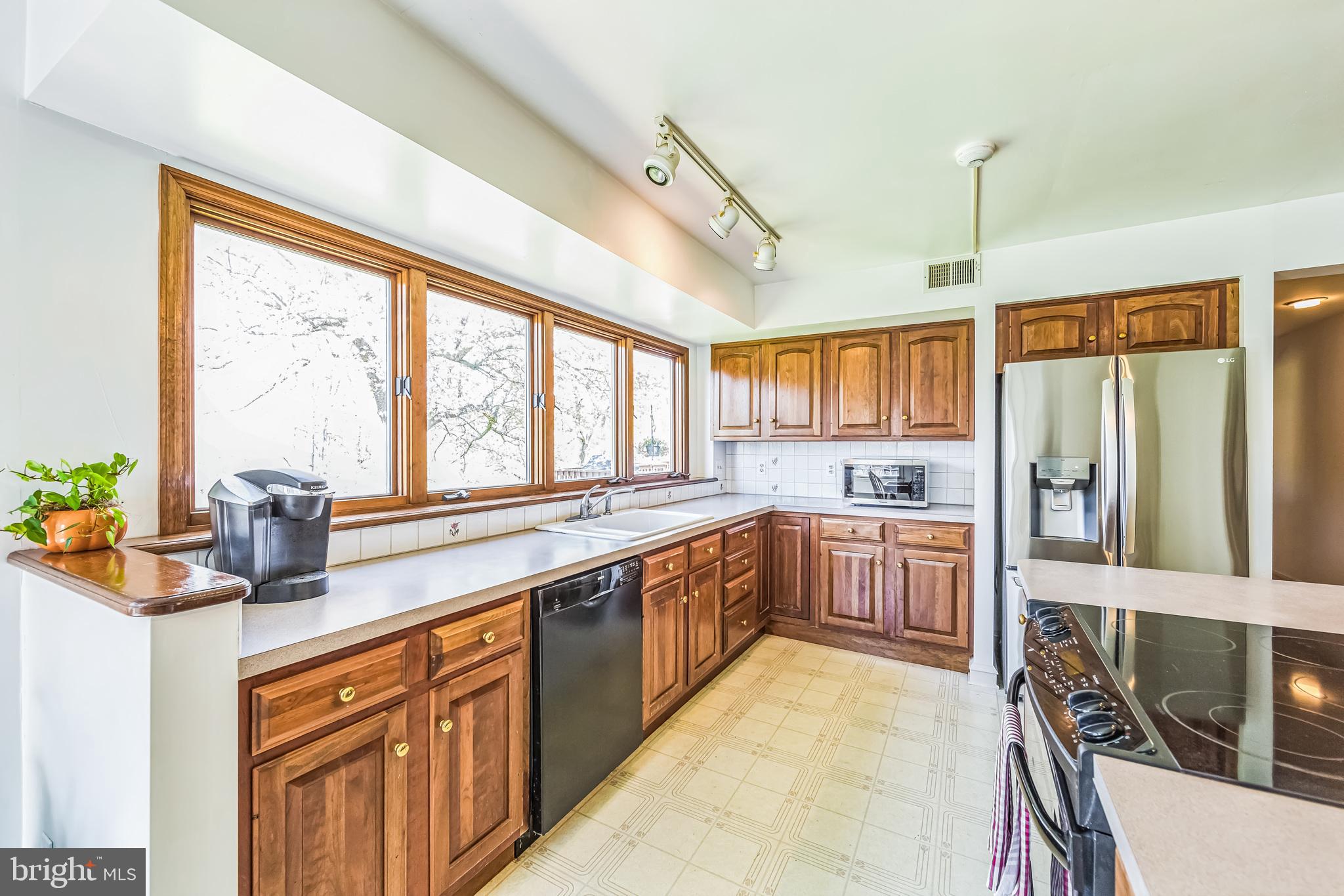 325 Tory Turn Wayne, PA 19087 - Photo 12 of 42 a large kitchen with kitchen island granite countertop a large window