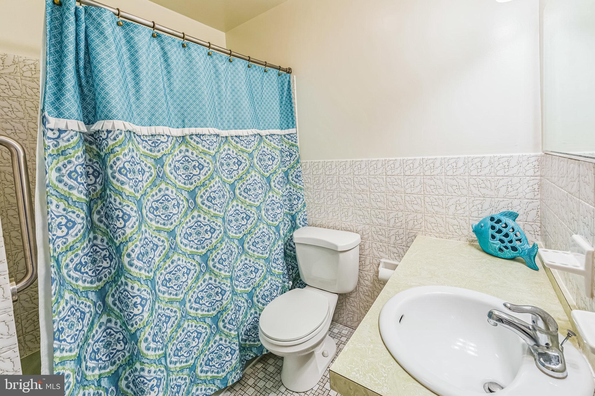 325 Tory Turn Wayne, PA 19087 - Photo 30 of 42 a white toilet sitting next to a sink and wooden floor
