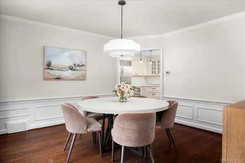 a view of a dining room with a table and chairs