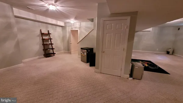 a view of a room with stairs and a ceiling fan
