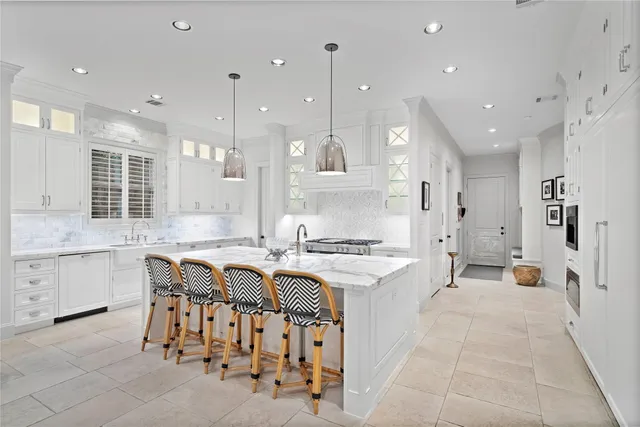 a large kitchen with kitchen island a sink a stove a center island a stove and a window