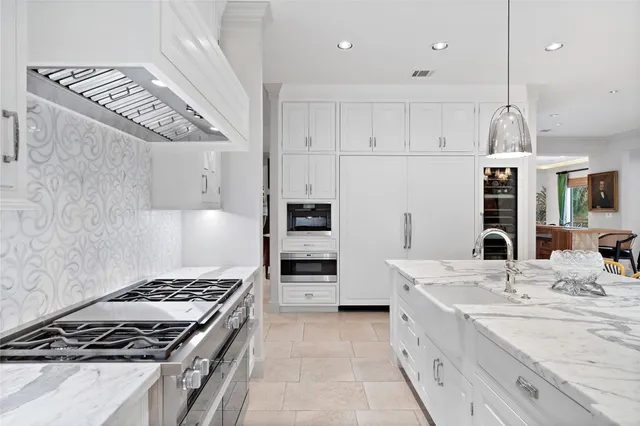 a kitchen with stainless steel appliances a stove a sink and a refrigerator