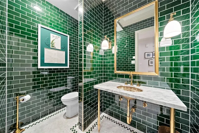 a bathroom with a sink a toilet and mirror