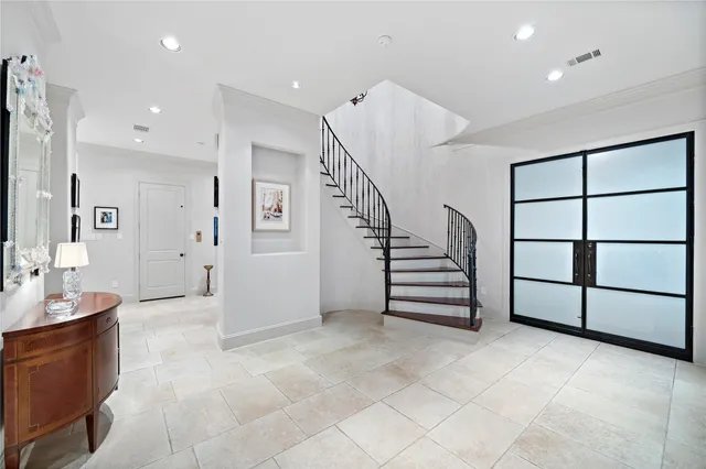a view of entryway with stairs and white cabinets