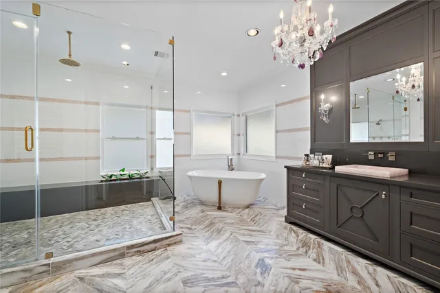 a large bathroom with a large tub sink and vanity
