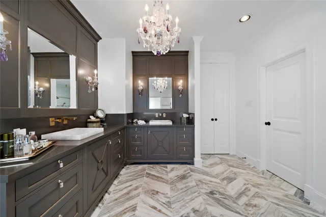 a spacious bathroom with a granite countertop sink a mirror and a shower