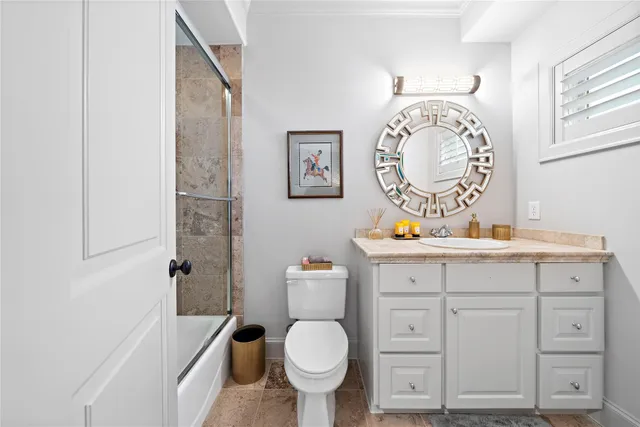 a bathroom with a toilet a sink and a mirror