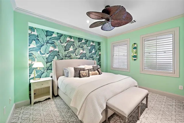 a bedroom with a bed chandelier and a window