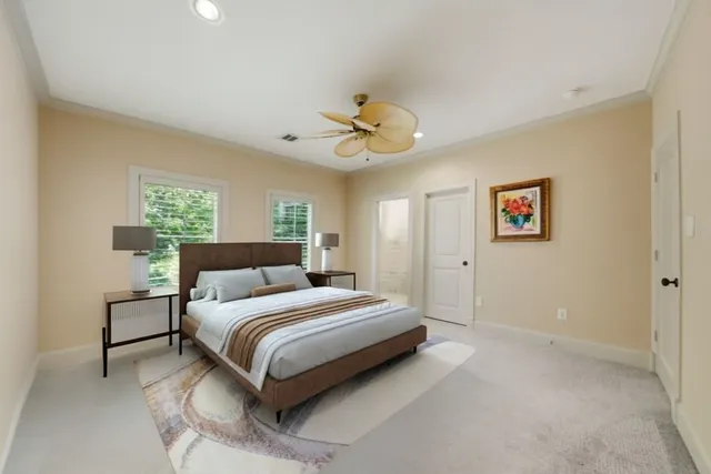 a spacious bedroom with a bed and a ceiling fan