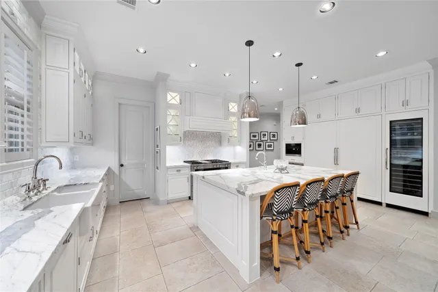 a kitchen with stainless steel appliances granite countertop a sink a stove and a refrigerator