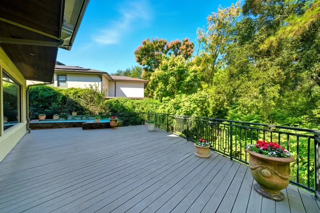 a view of a chairs and table on the wooden deck