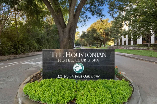 a view of sign board with a white fence