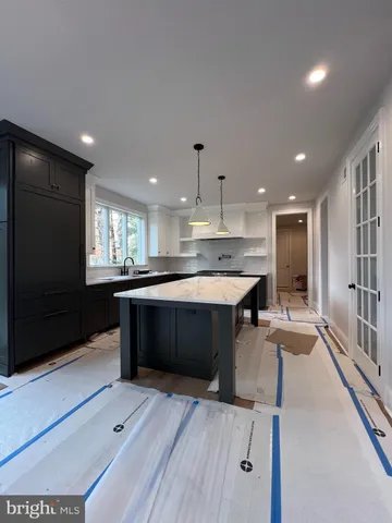 a large kitchen with stainless steel appliances a large counter top