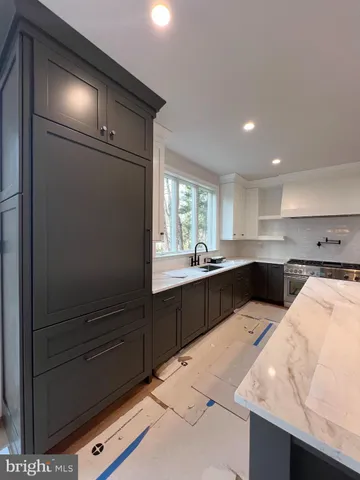 a kitchen with sink a microwave and cabinets
