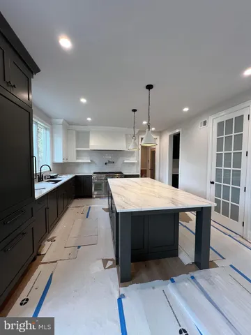 a kitchen with granite countertop a stove and a microwave