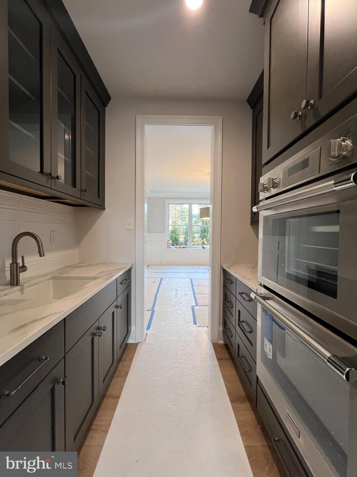 340 Hidden River Road Penn Valley, PA 19072 - Photo 26 of 57 a kitchen with sink a microwave and cabinets