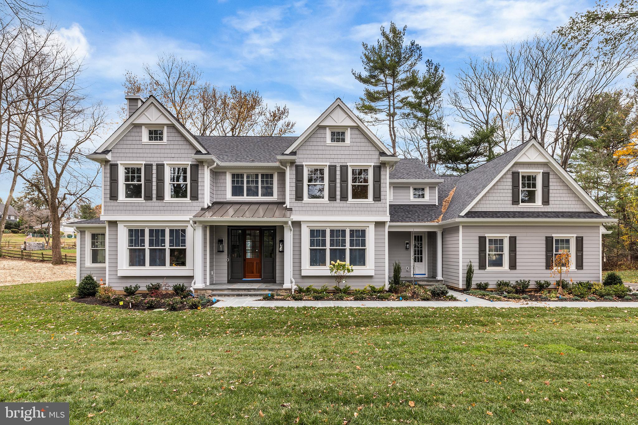 340 Hidden River Road Penn Valley, PA 19072 - Photo 3 of 57 a front view of a house with a garden and swimming pool