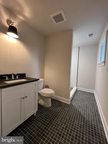 a view of room with window and wooden floor