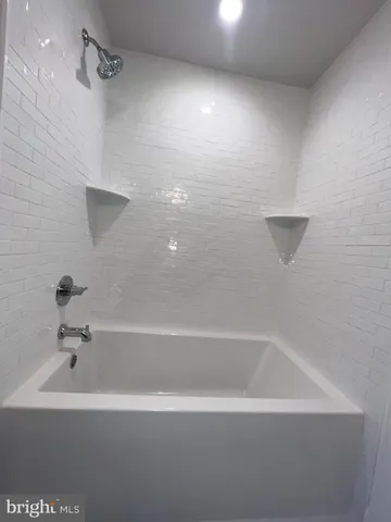 a front view of a house with parking space and trees