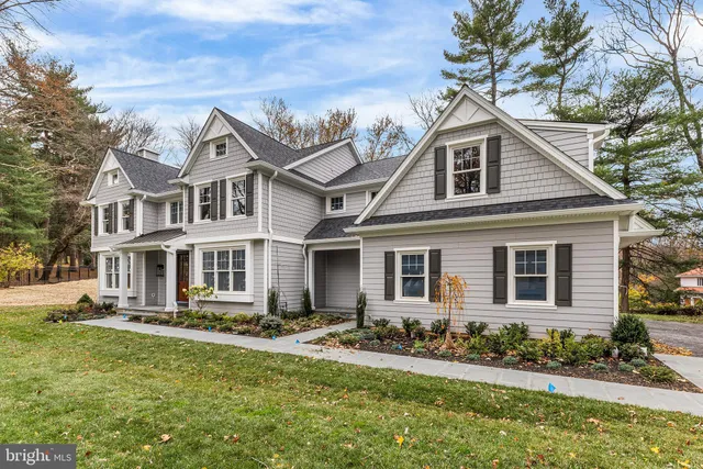 a front view of a house with a yard and outdoor seating