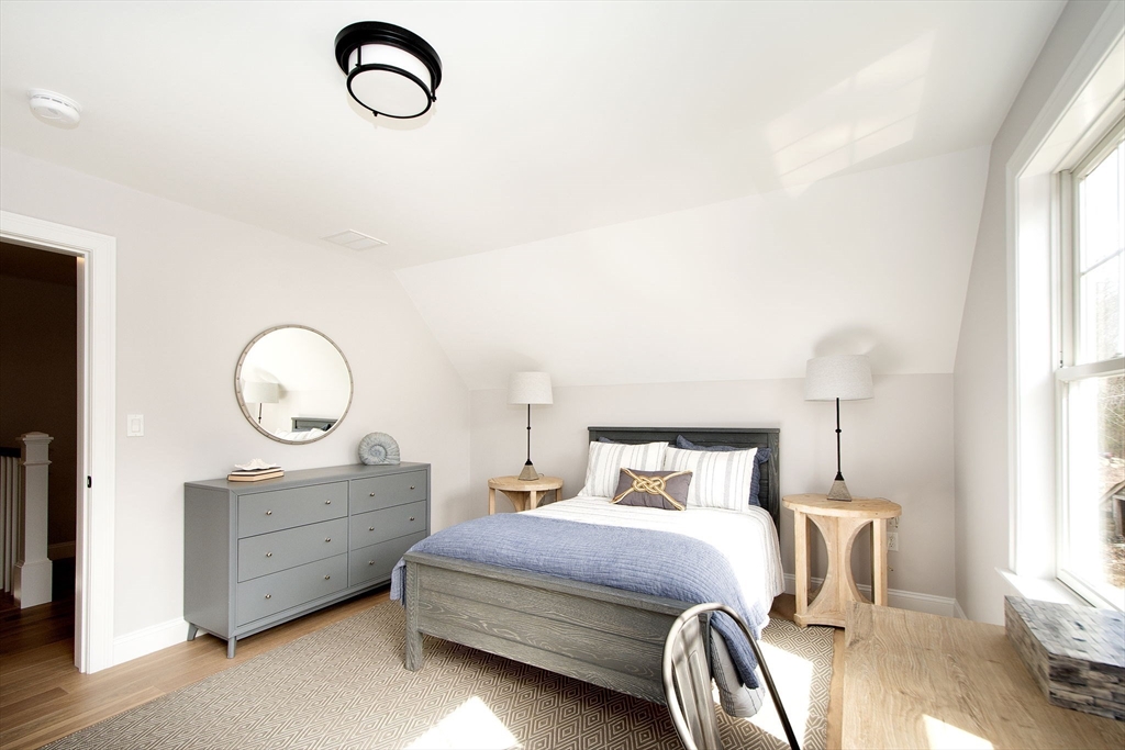 6 Grace Way, Unit 6 Scituate, MA 02066 - Photo 15 of 21 a bedroom with a bed and a chandelier