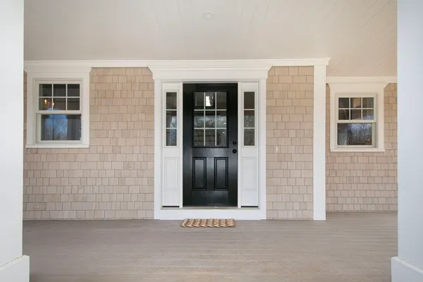 front view of a brick house with large windows