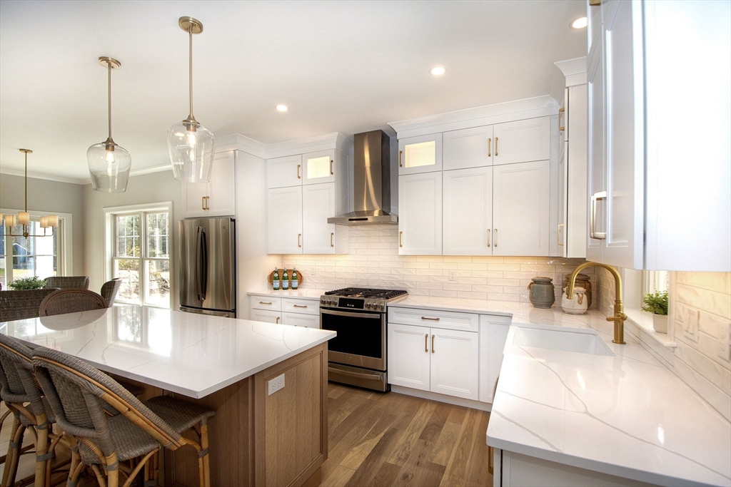 6 Grace Way, Unit 6 Scituate, MA 02066 - Photo 4 of 21 a kitchen with a sink a stove a refrigerator and white cabinets