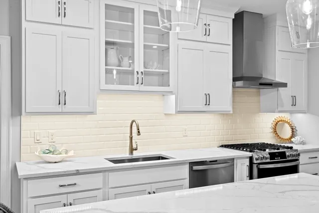 a kitchen with kitchen island a sink stove and refrigerator