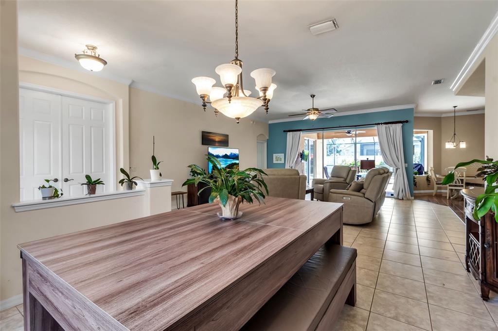 730 Old Quarry Road Bradenton, FL 34212 - Photo 11 of 65 a living room with dining table and wooden floor