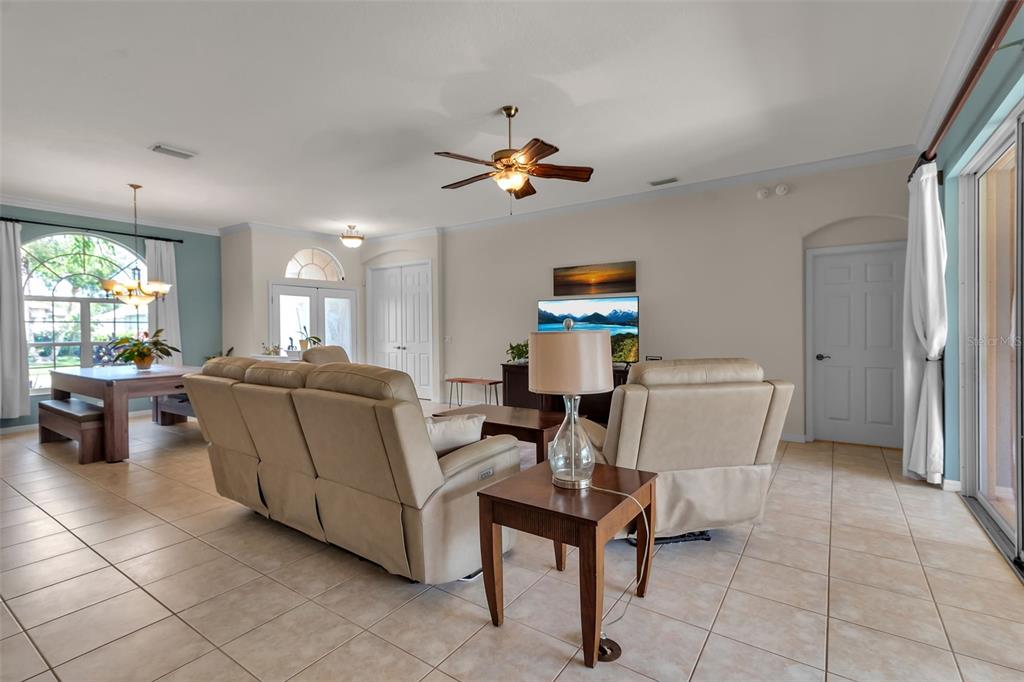 730 Old Quarry Road Bradenton, FL 34212 - Photo 15 of 65 a living room that has a couch and a chandelier with a large window