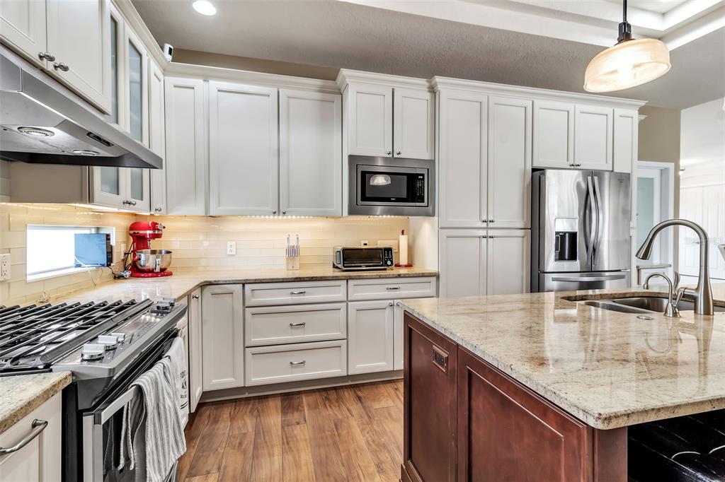 730 Old Quarry Road Bradenton, FL 34212 - Photo 25 of 65 a kitchen with stainless steel appliances granite countertop a stove refrigerator sink and microwave