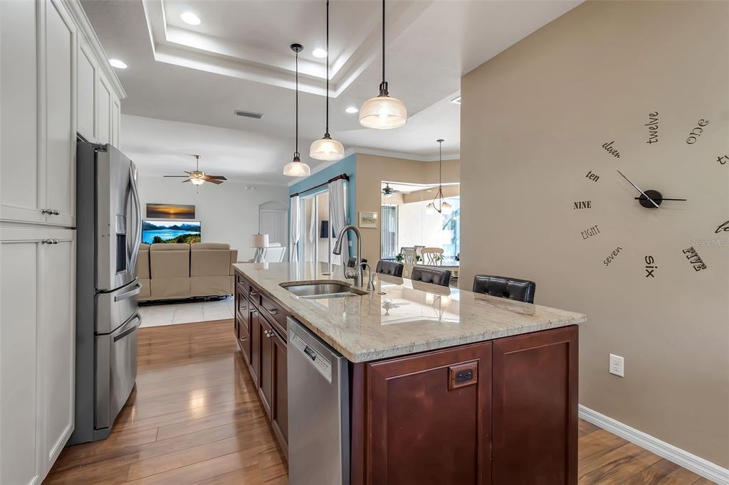 730 Old Quarry Road Bradenton, FL 34212 - Photo 26 of 65 a kitchen with a sink dishwasher a stove and a refrigerator with wooden floor