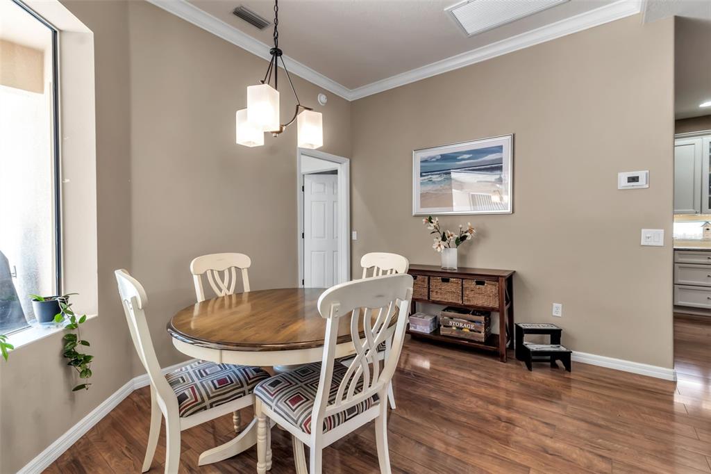 730 Old Quarry Road Bradenton, FL 34212 - Photo 29 of 65 a view of a dining room with furniture wooden floor and a chandelier