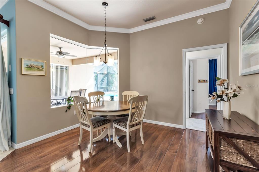 730 Old Quarry Road Bradenton, FL 34212 - Photo 30 of 65 a dining room with furniture a chandelier and wooden floor