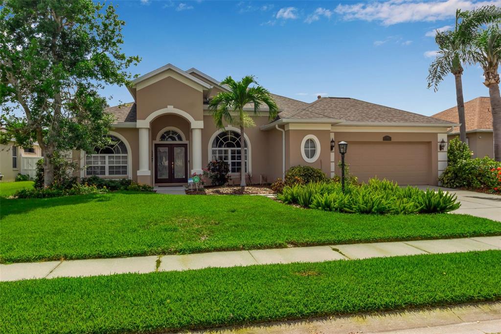 730 Old Quarry Road Bradenton, FL 34212 - Photo 3 of 65 a front view of a house with a garden and plants