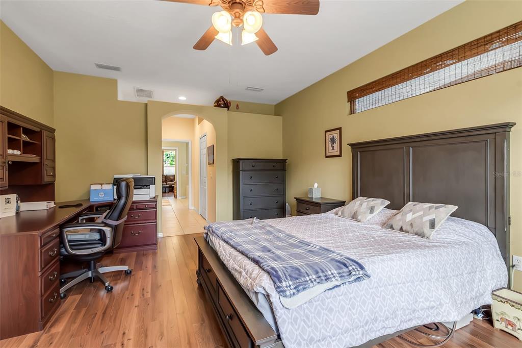 730 Old Quarry Road Bradenton, FL 34212 - Photo 32 of 65 a bedroom with a bed and a chandelier