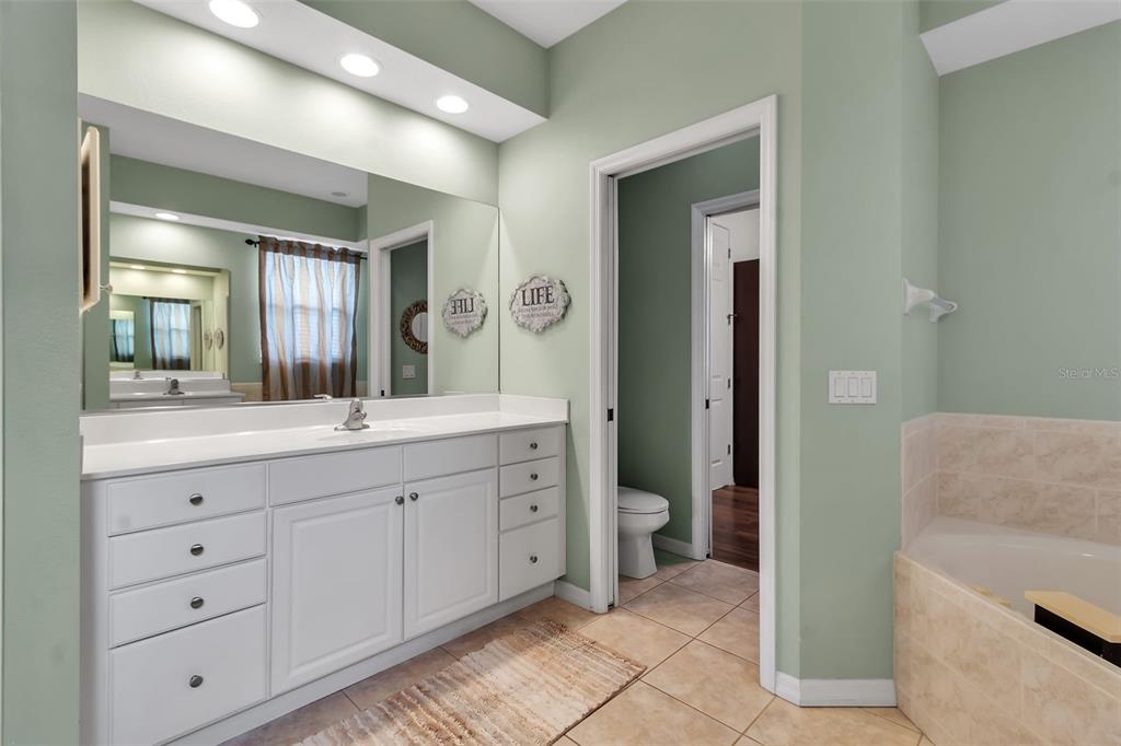 730 Old Quarry Road Bradenton, FL 34212 - Photo 39 of 65 a spacious bathroom with a granite countertop sink mirror and a toilet