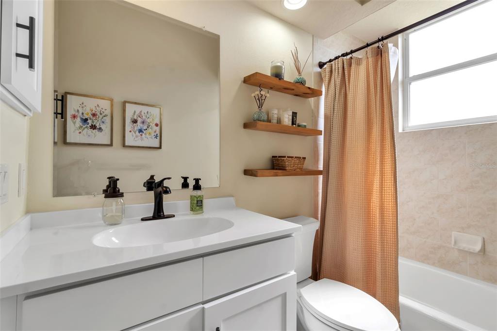 730 Old Quarry Road Bradenton, FL 34212 - Photo 48 of 65 a bathroom with a sink a toilet and shower curtain