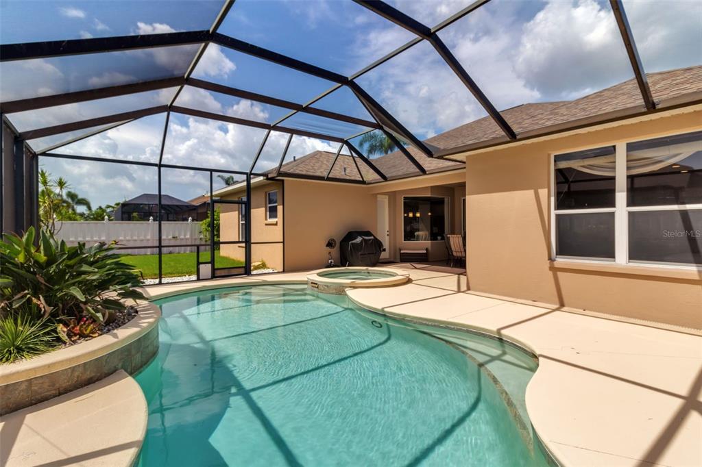 730 Old Quarry Road Bradenton, FL 34212 - Photo 61 of 65 a view of a backyard with table and chairs under an umbrella