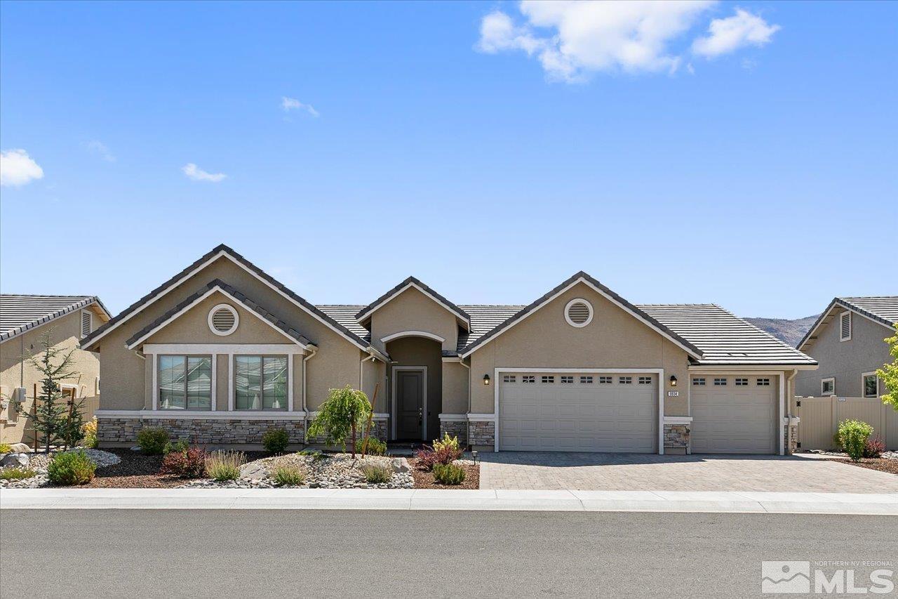 9934 Autumn Sage Drive Reno, NV 89521 - Photo 1 of 39 a front view of a house with a yard and garage