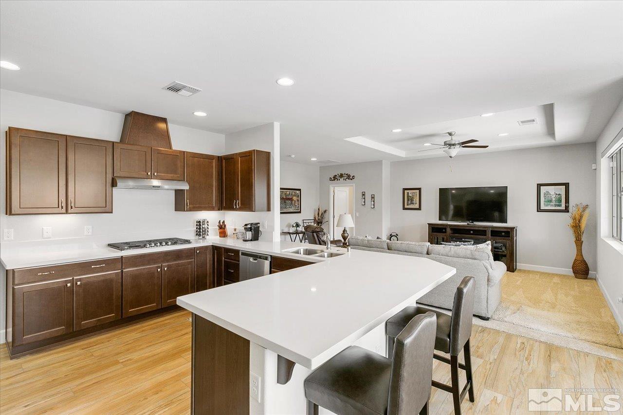 9934 Autumn Sage Drive Reno, NV 89521 - Photo 13 of 39 a large kitchen with stainless steel appliances lots of counter space and breakfast area