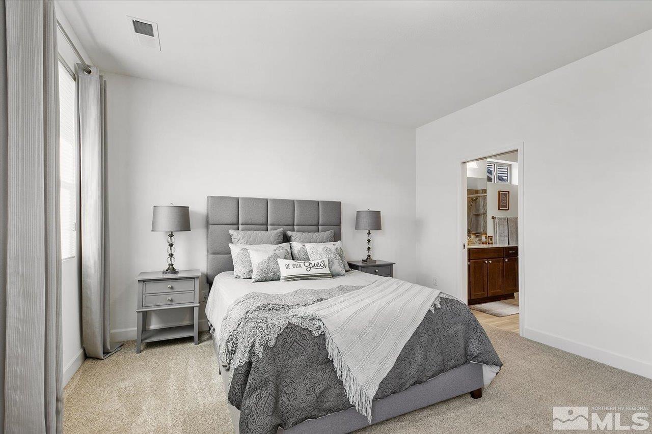 9934 Autumn Sage Drive Reno, NV 89521 - Photo 18 of 39 a bedroom with a bed and a lamp