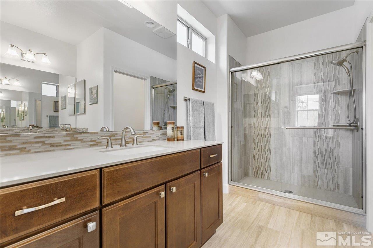 9934 Autumn Sage Drive Reno, NV 89521 - Photo 21 of 39 a bathroom with a shower sink and mirror