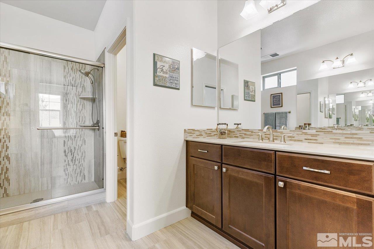 9934 Autumn Sage Drive Reno, NV 89521 - Photo 22 of 39 a bathroom with a shower sink and mirror