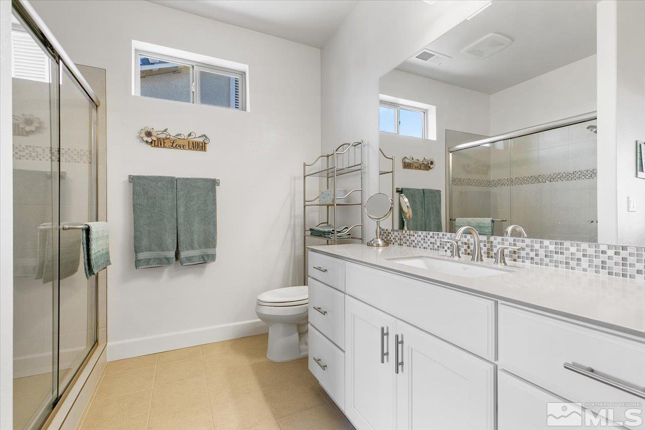 9934 Autumn Sage Drive Reno, NV 89521 - Photo 29 of 39 a bathroom with a granite countertop sink toilet and shower