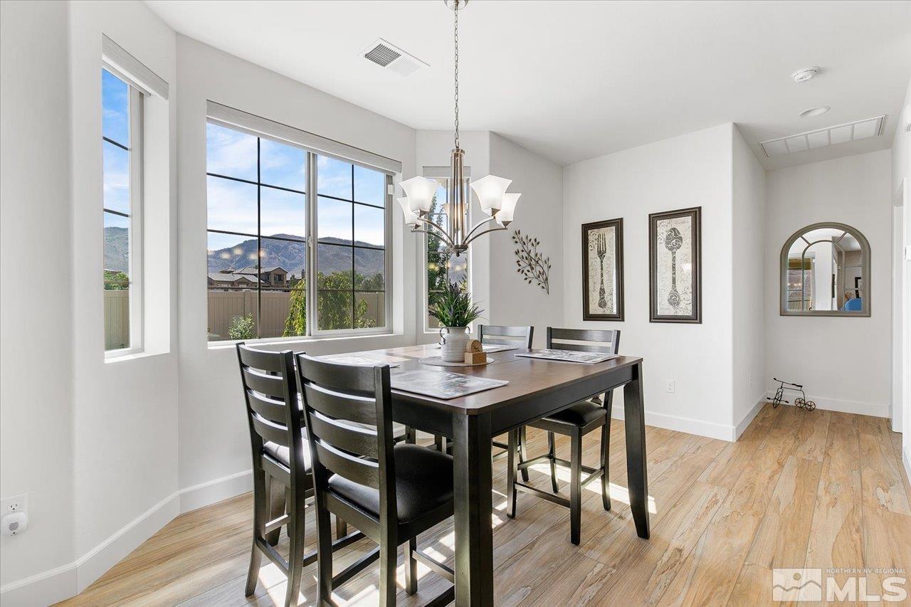 9934 Autumn Sage Drive Reno, NV 89521 - Photo 9 of 39 a view of a dining room with furniture window and wooden floor
