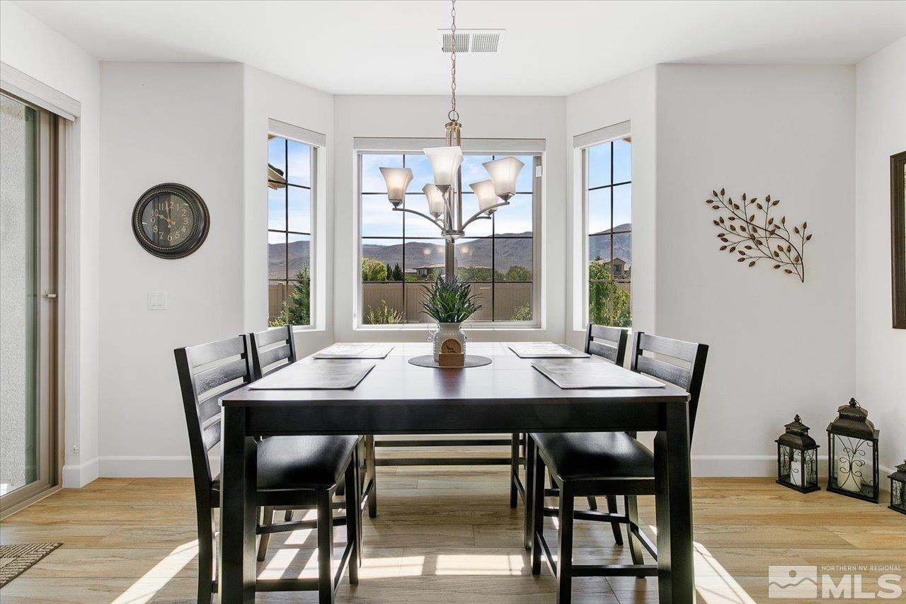 9934 Autumn Sage Drive Reno, NV 89521 - Photo 10 of 39 a dining room with furniture a rug and a large window