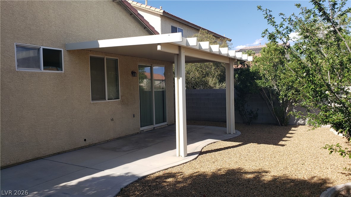 9112 Manalang Road Las Vegas, NV 89123 - Photo 15 of 50 A private backyard oasis with a covered patio, perfect for enjoying outdoor living and desert-friendly landscaping.