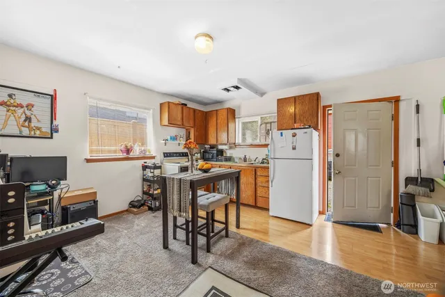 a kitchen with stainless steel appliances granite countertop a refrigerator and a stove top oven