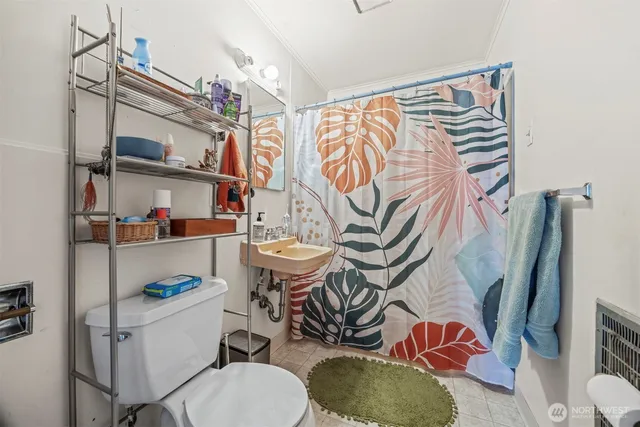 a bathroom with a sink toilet and a mirror